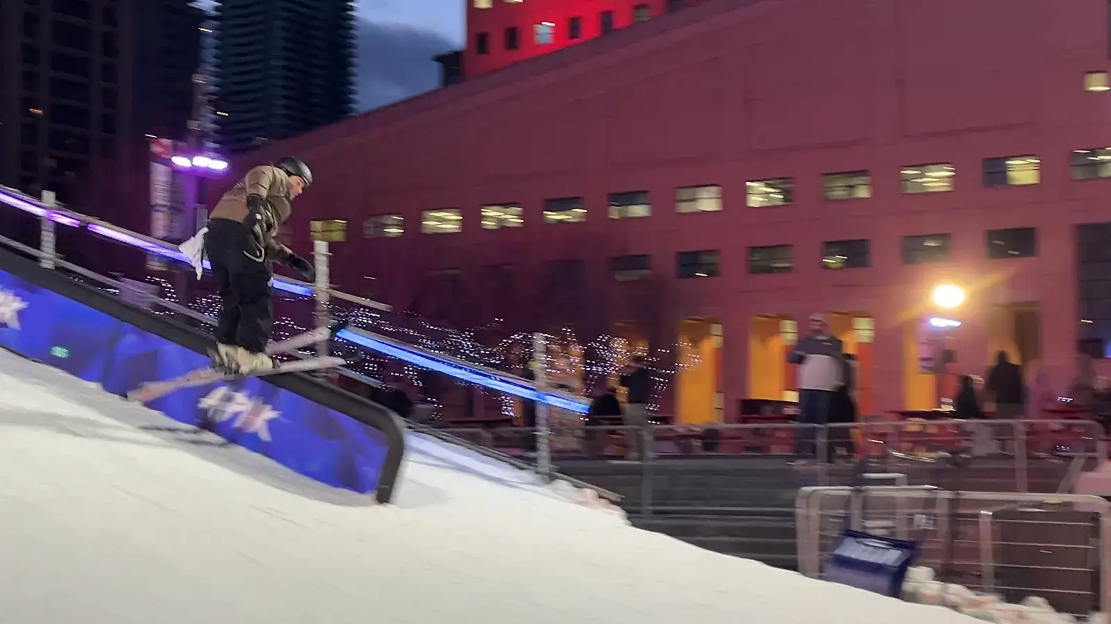 A snowboard ramp built in the middle of Celebration Square at dusk