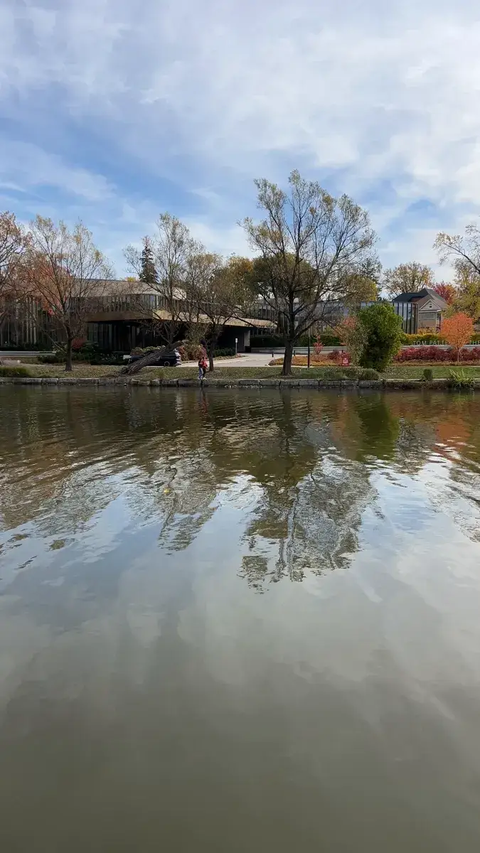 Calm Avon River reflecting autumn trees and houses