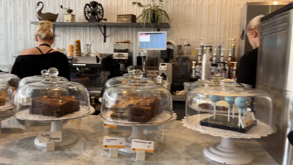 Cakes under glass domes on the counter at Balzac's Coffee
