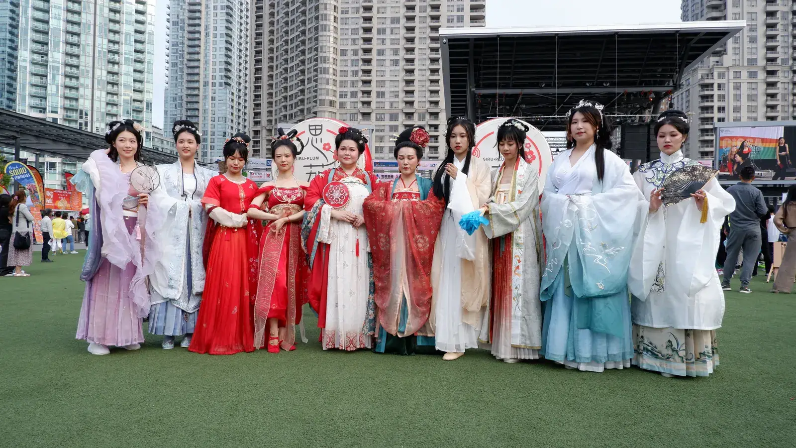 Performers in traditional Chinese dress on the Celebration Square lawn