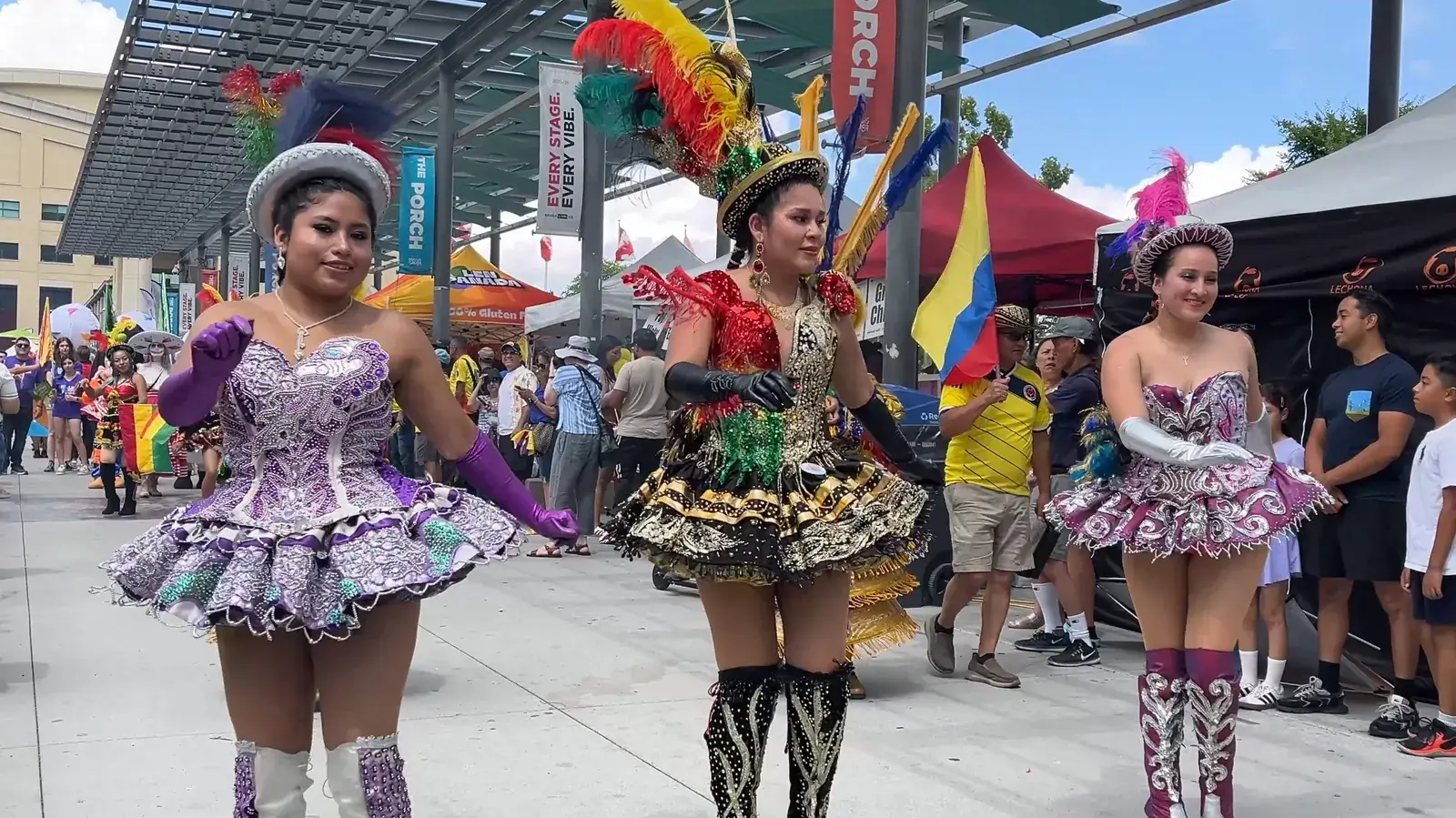 Dancers in colourful sequined dresses at the Latin Festival parade
