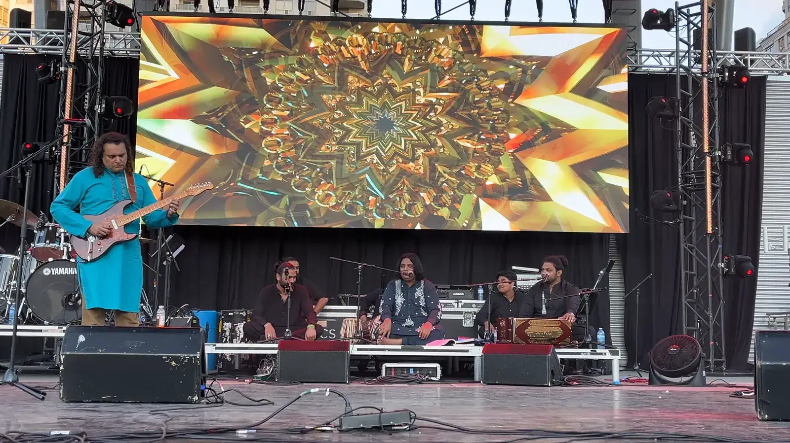 Mekaal Hasan Band with a bright stage screen behind