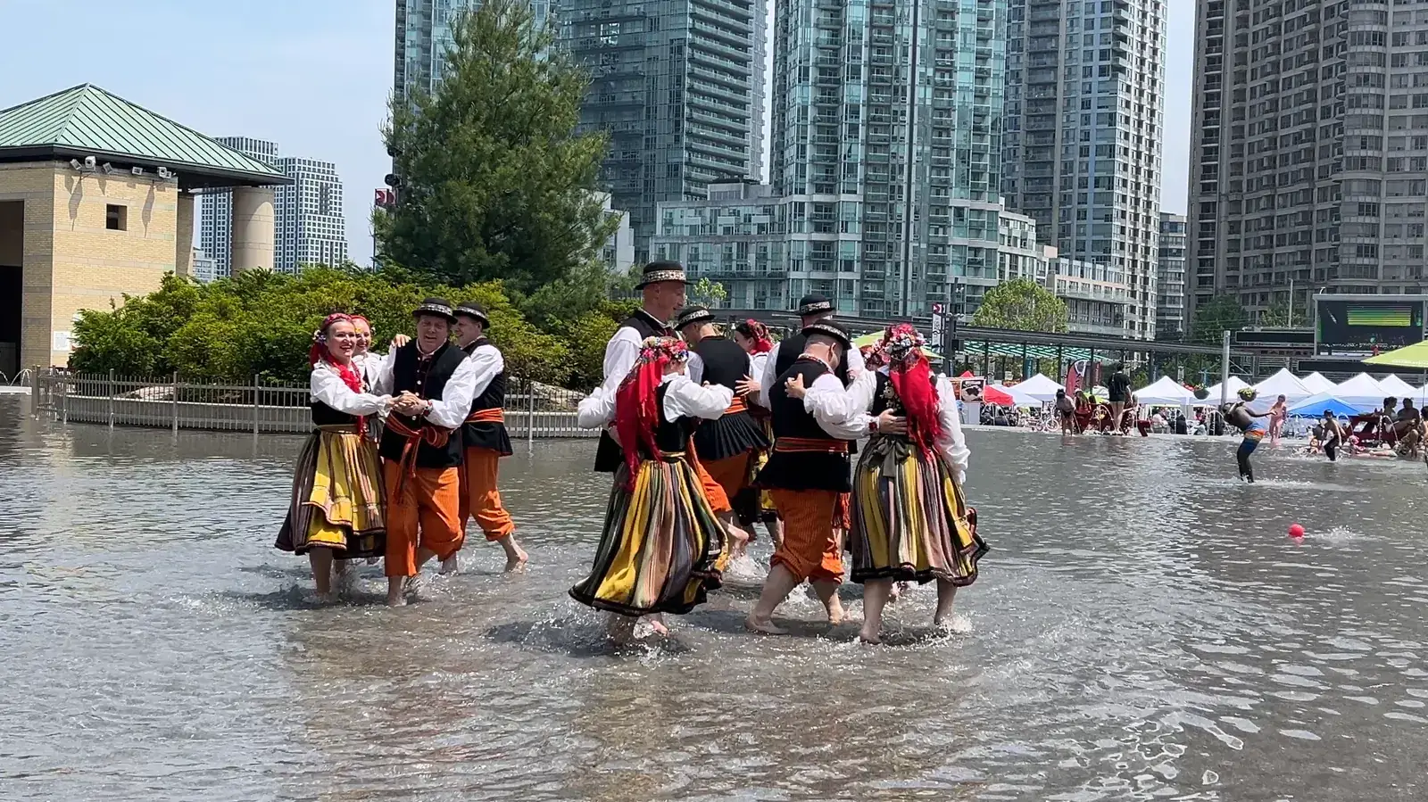 Polish folk dancers in traditional costume dancing in the fountain pool