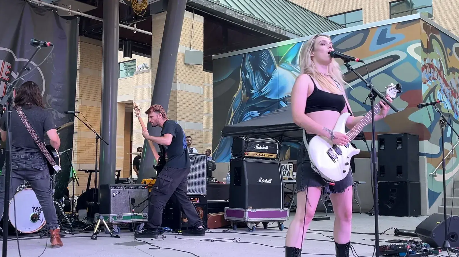 A rock band playing on an outdoor stage